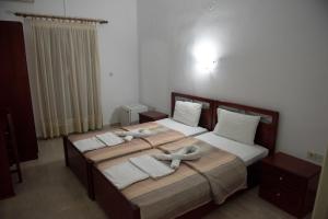 Postel nebo postele na pokoji v ubytování Hotel Glaros