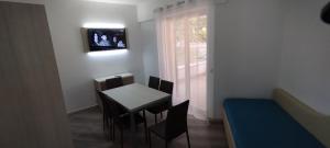 a dining room with a table and chairs and a window at Appartamento Parco Urciuolo Cirella in Cirella
