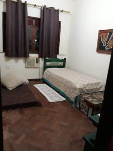 een kleine kamer met 2 bedden en een raam bij Bedroom near Forest in Rio de Janeiro