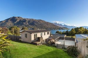 a house with a yard with a fence at Lake and Mountain view living in Queenstown