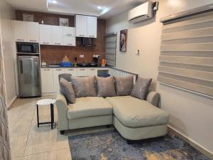 a living room with a couch in a kitchen at The Leneade in Abuja