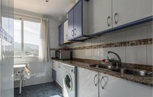 a kitchen with a sink and a washing machine at Lovely Apartment In Puente De Genave in Puente de Génave