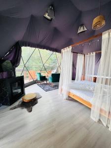a bedroom with a canopy bed in a tent at ME-GA Glamping in Sapanca