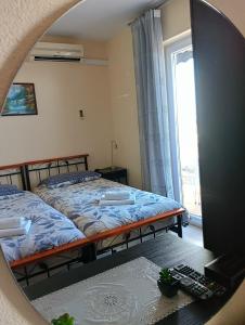 a bedroom with two beds and a mirror at Rooms Ivan in Dubrovnik