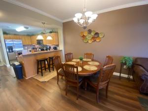 a dining room and kitchen with a table and chairs at River Crossing Resort in Pigeon Forge
