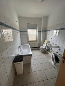 a bathroom with a tub and a toilet and a sink at Monteurwohnung in Leipzig in Leipzig