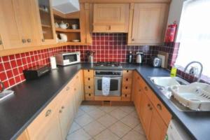 a kitchen with a sink and a stove top oven at Tivoli villas in New Brighton