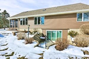 una casa con la neve davanti di Beaver Dam Lake Retreat with Fire Pit and Dock! a Beaver Dam