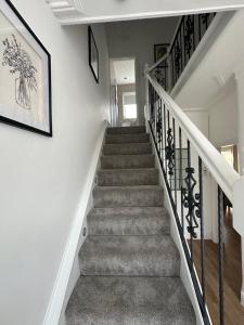 a staircase in a home with white walls and a stair case at Watford Road House Liverpool in Liverpool