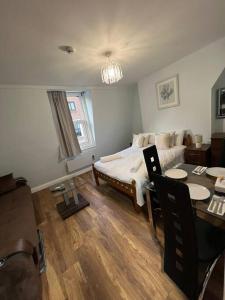 a bedroom with a bed and a table and chairs at 008- S2Premium location studio apartment central London in London