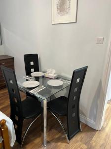 a black table with black chairs and a table with plates on it at 008- S2Premium location studio apartment central London in London