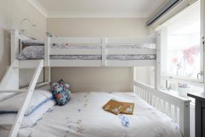 a bedroom with two bunk beds with a book on the bed at Needles Point in Milford on Sea