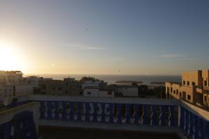 a view of the sunset from the balcony of a building at zina surf house in Oualidia