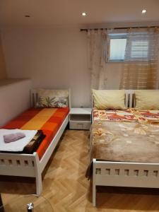 a bedroom with two beds and a window at Apartments Nena in Split