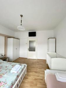 a white room with two beds and a couch at Apartmán Markéta in Bystrzyca