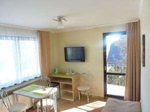 クリニツァ・ズドルイにあるArnika Apartmentのリビングルーム(テーブル、椅子、テレビ付)