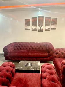ダカールにあるRelax red Almadieのリビングルーム(赤いソファ、椅子2脚付)