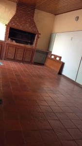 an empty room with a fireplace and a tiled floor at Casa de Tigres in Tigre