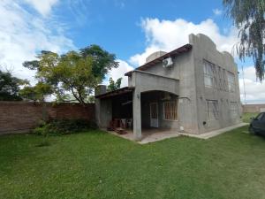 a house with a grass yard in front of it at Cabañas Florida Del Sur in San Rafael