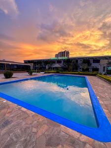 a large blue swimming pool in front of a building at Hotel Fatima in Tete