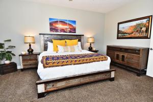 a bedroom with a large bed and two night stands at Entrada at Moab 624 and 632 in Moab +97 photos
