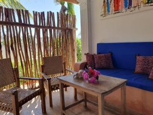 a living room with a couch and a table and chairs at BARIDI VILLA in Kiwengwa