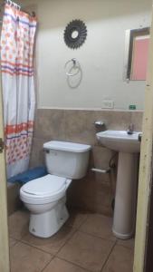 a bathroom with a toilet and a sink at La Querencia in Cuenca