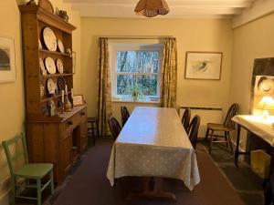 a dining room with a table and chairs and a window at Fawber Cottage in Horton in Ribblesdale