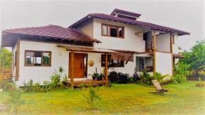 a small white house with a chair in front of it at Morada Luz das Estrelas Barra Grande in Marau