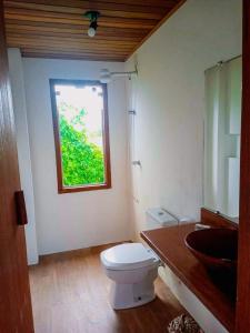 a bathroom with a toilet and a window at Morada Luz das Estrelas Barra Grande in Marau