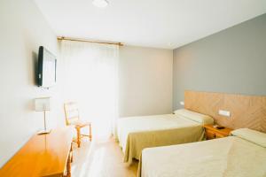 Postel nebo postele na pokoji v ubytování Hotel La Colina