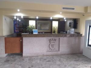 a bar in a store with a counter with writing on it at Hotel POSADA DEL REY in Matamoros