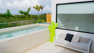 a living room with a swimming pool and a couch and a large window at Siaan Betine 4br Deluxe PDC in Playa del Carmen
