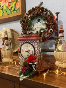 a clock sitting on top of a table with a wreath at Agriturismo Is Conchisceddas in Gonnosfanàdiga