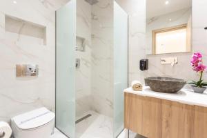 a bathroom with a sink and a shower at Eva's House in Afitos
