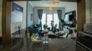 sala de estar con sofá y mesa en Your 1BR Retreat on Yas Island Blue Sapphire Apartment, en Abu Dabi