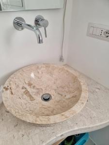 a bathroom sink with a wooden counter top at Villa Rosa in Bari Sardo
