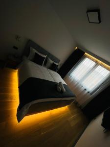 a bedroom with a large bed and a window at Crystal Apartments Old Town Sarajevo in Sarajevo