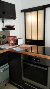a kitchen with a counter with a stove top oven at A la Tour des Rohan in Strasbourg