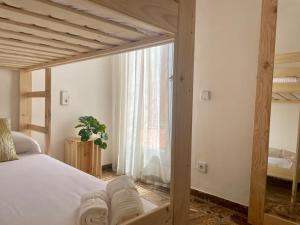 a bedroom with a bed and a large window at El Mirador: Un lugar único en el Corazón del Delta in Els Muntells