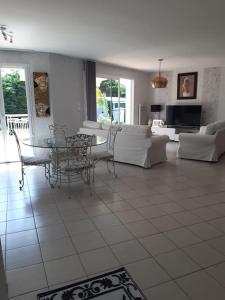 a living room with a couch and a table and chairs at Les vignobles du Bordelais in Montussan