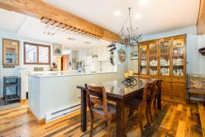 a kitchen with a dining room table and chairs at Camp Cottonwood in Teton Village