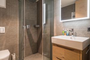 a bathroom with a sink and a shower at Apartment in Chalet Pizzo Fiamma in Zermatt