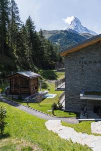 a log cabin with a mountain in the background at Apartment in Chalet Pizzo Fiamma in Zermatt