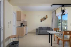 a kitchen and living room with a table and a couch at Astronomy Studios in Faliraki