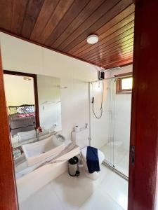 a bathroom with a sink and a shower and a toilet at Pousada Pedras Quentes in Lençóis