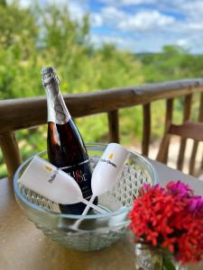 a bottle of champagne in a basket on a table at Pousada Pedras Quentes in Lençóis