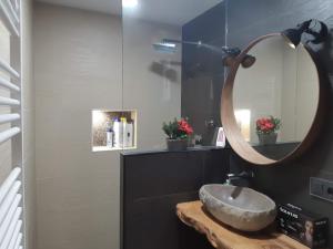 ein Bad mit einem Waschbecken und einem Spiegel in der Unterkunft Lucky House in Badalona