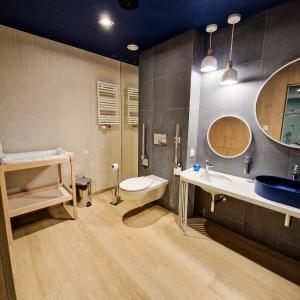 a bathroom with a sink and a toilet at Piękny Puck Apartamenty z tarasami in Puck +39 photos