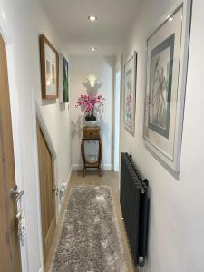 a hallway with a staircase with a vase of flowers at Luxury Accomodation close to city centre in Plymouth